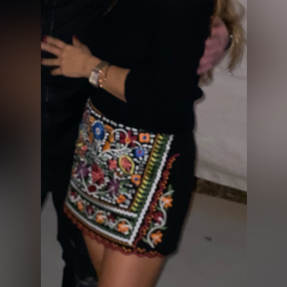 Beautiful embroidered mini skirt and off shoulder sweater .